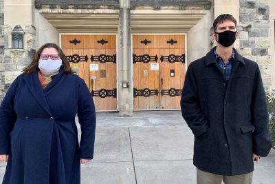 Andi Ogier and Jonathan Petters stand in front of an entrance to Newman Library in Blacksburg, Va.