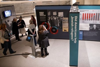 People are viewing the exhibit and discussing its content.