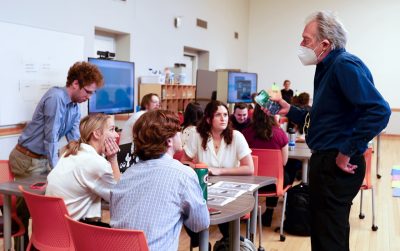 Honors College dean Paul Knox talks to Honors SuperStudio students seated at a table