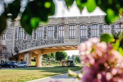 Torgersen Bridge framed by summer leaves and flowers