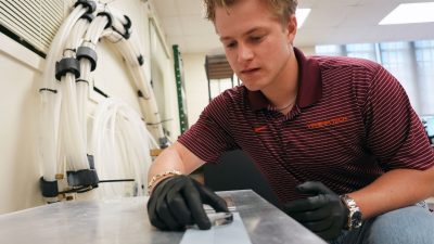 PhD student Jack Tapocik sets up ice on an engineered surface in the lab of Jonathan Boreyko. Photo by Alex Parrish for Virginia Tech.