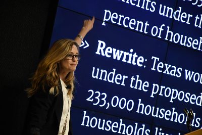 Regina Nuzzo  points to information about statistics on a screen as part of a previous presentation.