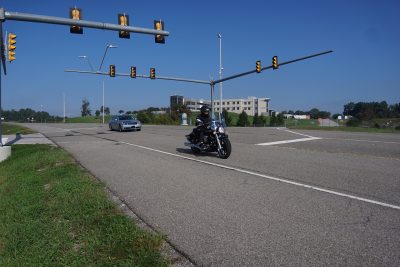 Car and motorcyle on a road